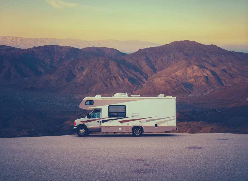 rv parked in front of desert mountains