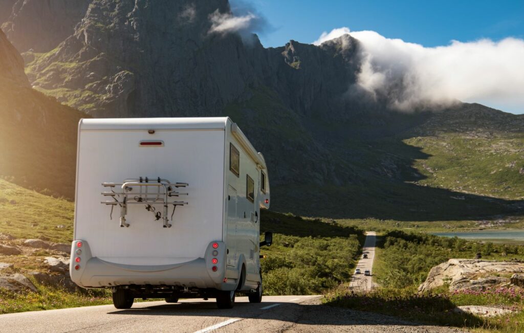 back of Rv on a road up to the mountains